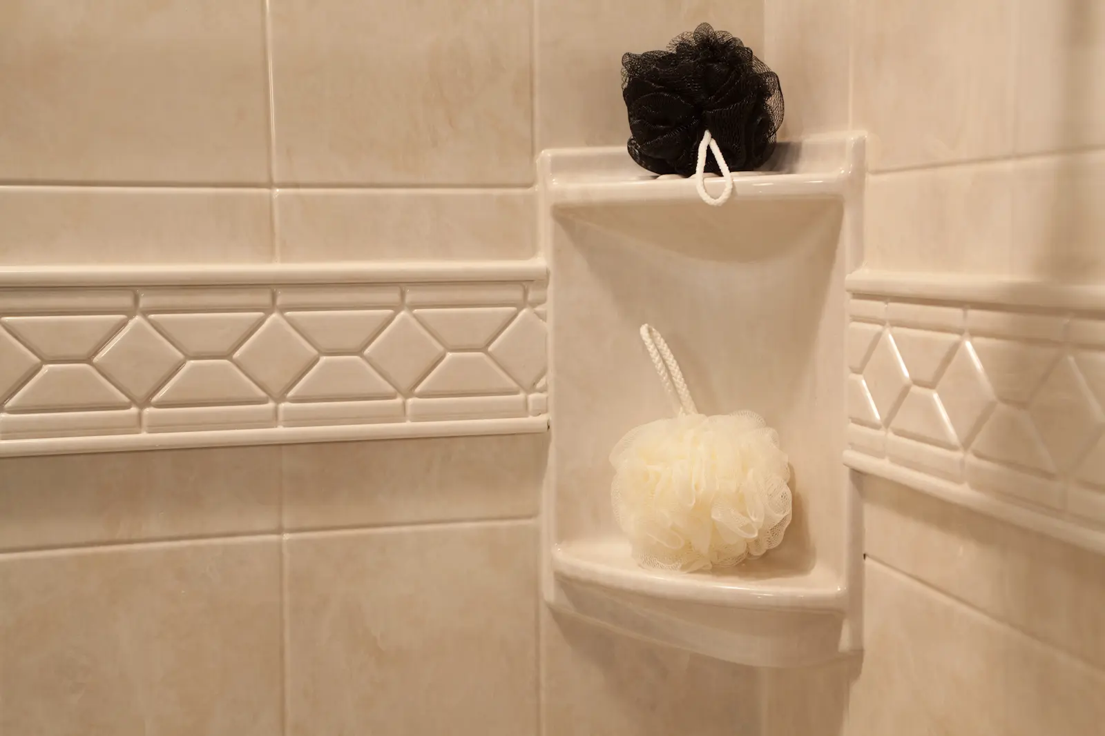 Travertine two-shelf corner caddy with 8x10 walls and listello trim