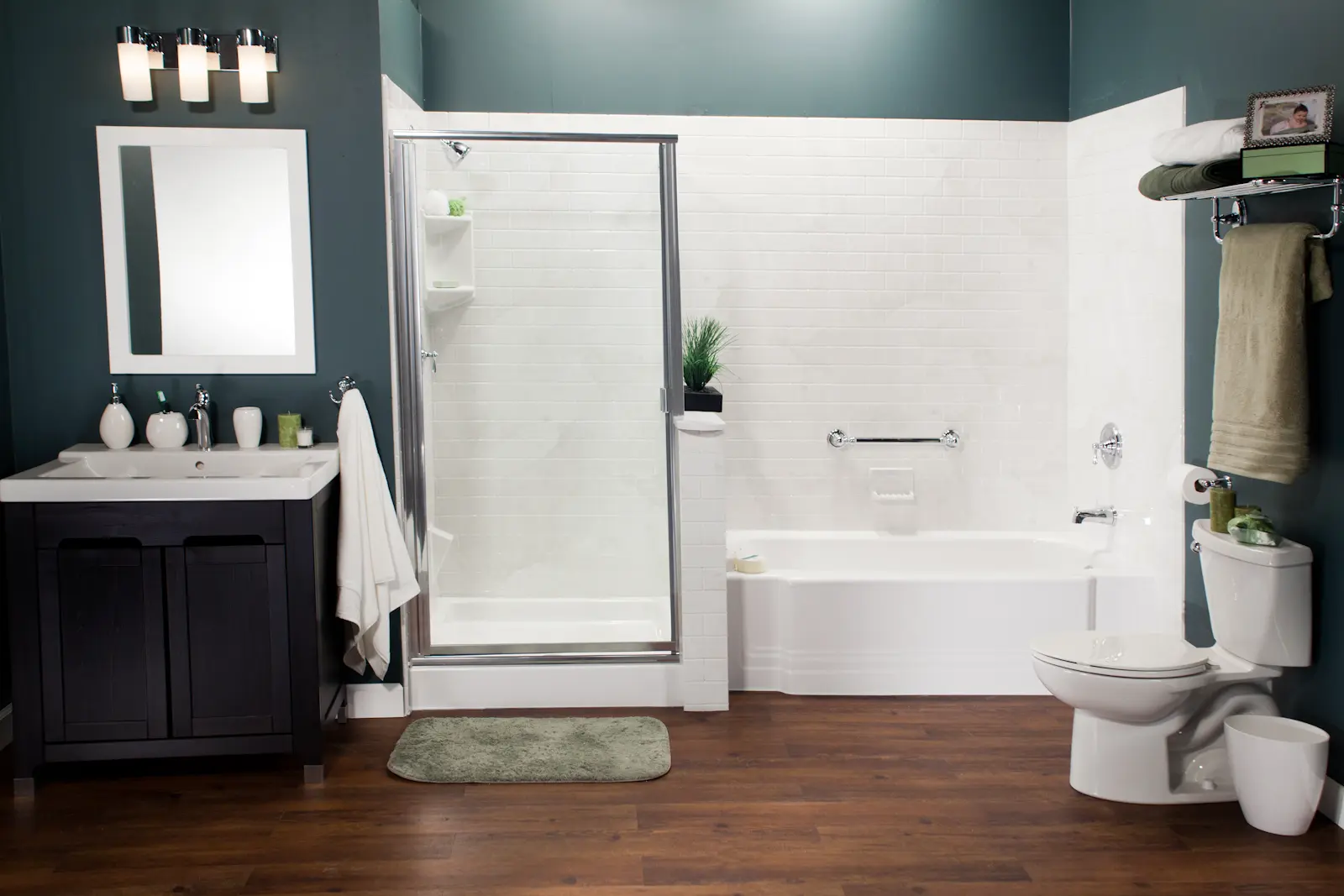 White bath and shower combo with subway tile walls and polished chrome in teal bathroom