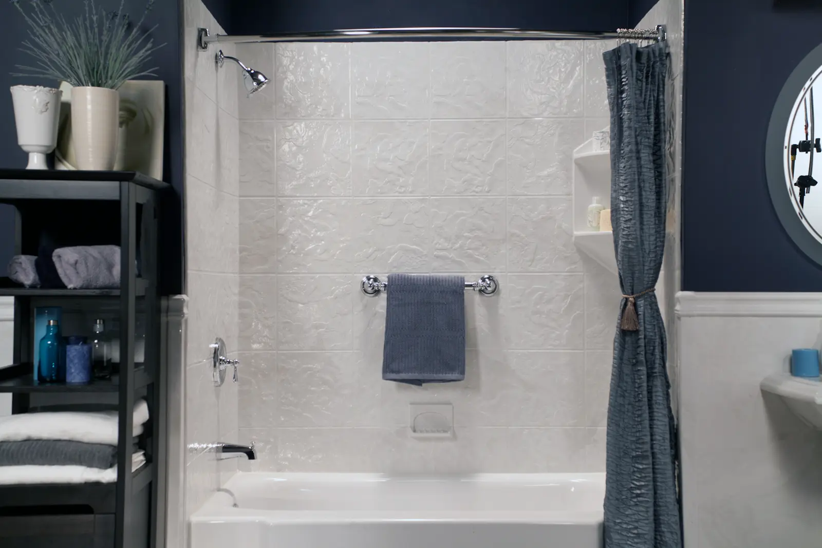 White classic tub and shower with silver white textured walls and polished chrome